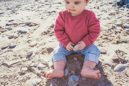 Little baby discovering the sand and sea
