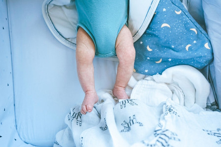 Close up of newborn legs at home
