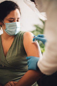 Woman getting coronavirus vaccine at home