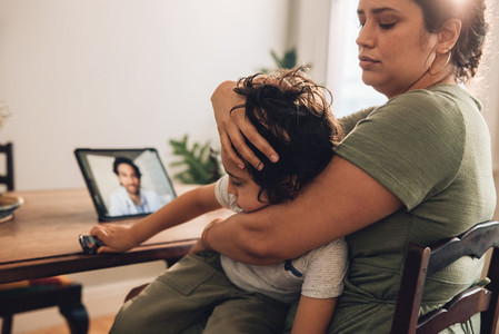 Woman with sick son having online consultation with family docto