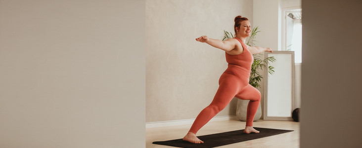 Woman doing yoga workout at fitness studio
