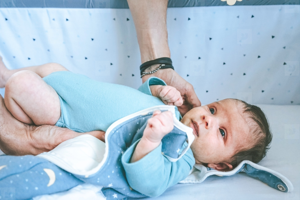 Father trying to relax his baby to sleep