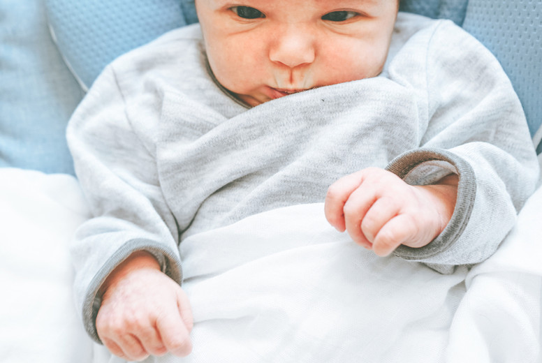 Little new born girl lying down and trying to relax