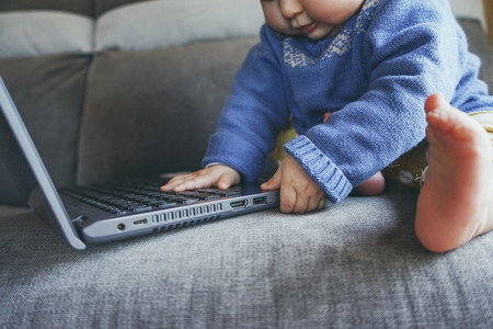 Close up of a baby using a laptop