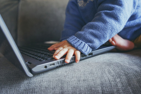 Close up of a baby using a laptop