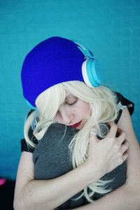 Beautiful blonde woman listening to music