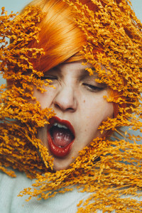 Moody portrait in orange tones of a white woman