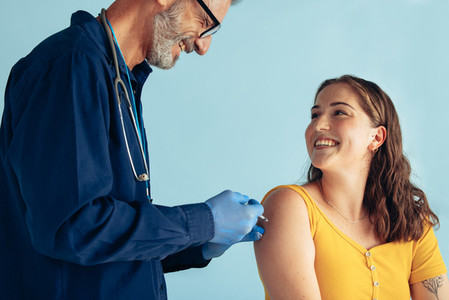 Doctor giving flu shot to a woman