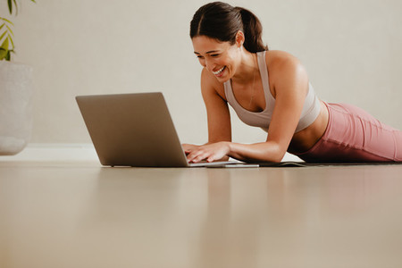 Fitness instructor using laptop