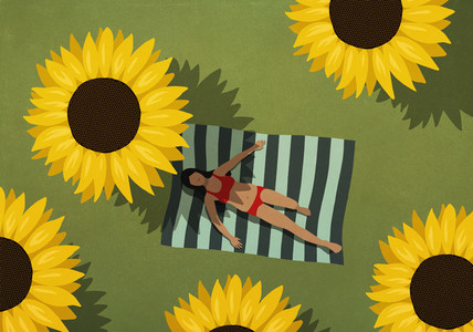 Woman in bikini sunbathing on blanket among large sunflowers