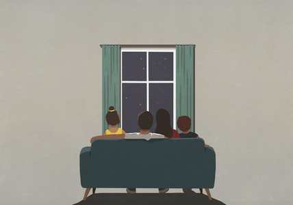 Family on sofa looking out window at starry night sky