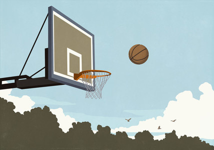 Basketball flying midair toward basketball net