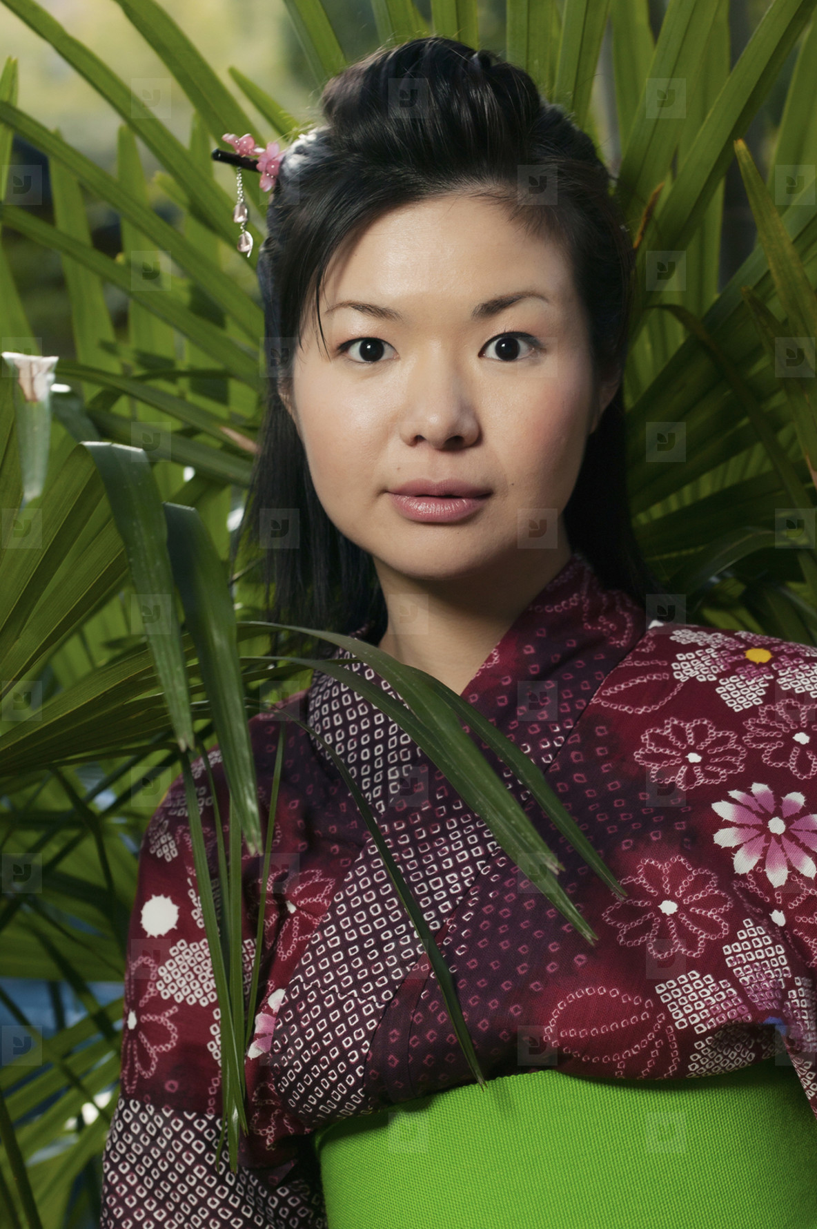 Portrait beautiful young woman in kimono among plants