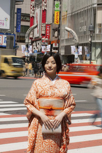 Portrait beautiful young woman in kimono on busy city street Izu Japan