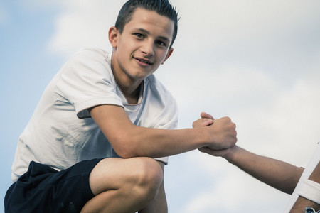 Portrait confident teenage boy holding hands with friend