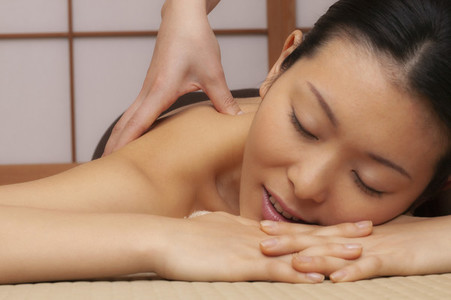 Close up beautiful serene young woman receiving massage at spa