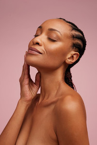 Woman touching her smooth and healthy facial skin