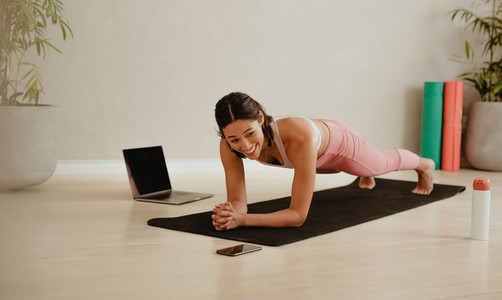 Fitness woman holding plank position