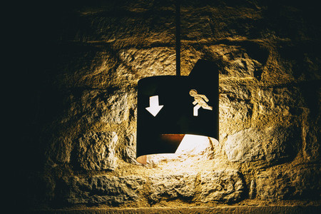 old fashioned emergency exit icon with backlit arrow