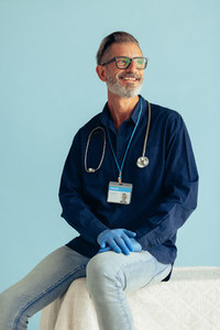 Medical professional smiling on blue background