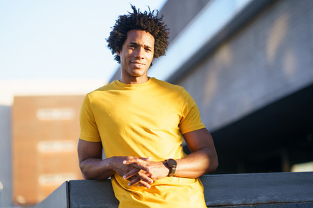 Black man with afro hair taking a break after workout