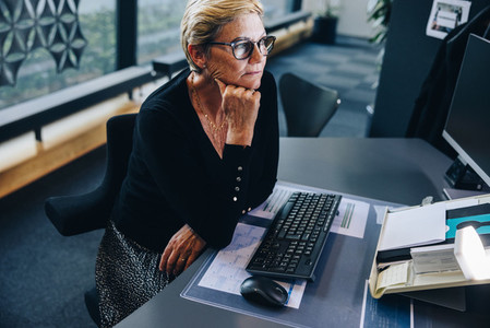 Senior businesswoman sitting at her desk