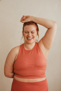 Plus size looking happy after workout session