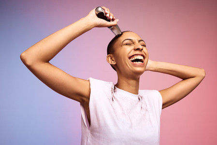Bold and liberated woman shaving her head