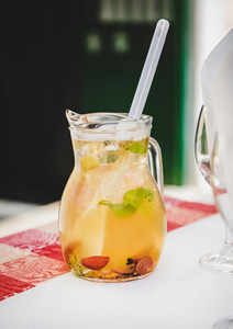 Jug of fresh cold white wine Sangria with fruit