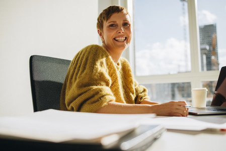 Smiling woman sitting in office