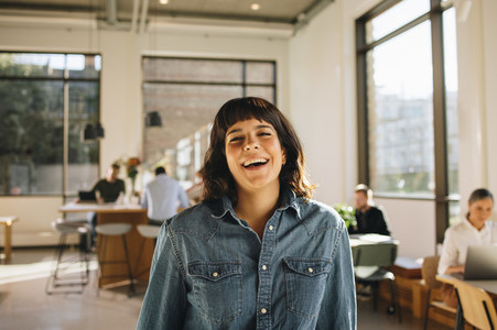 Smiling female freelancer in co working space