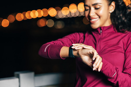 Close up of a sportswoman checking smartwatch on her wrist