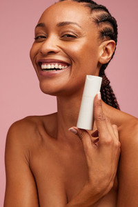 Smiling woman presenting beauty product