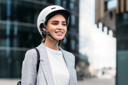 Portrait of a beautiful smiling businesswoman with a white safety helmet on head