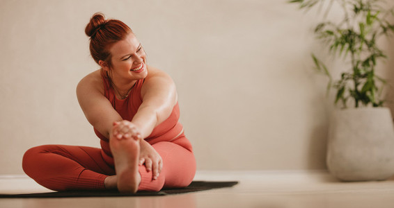 Smiling woman doing stretching leg workout