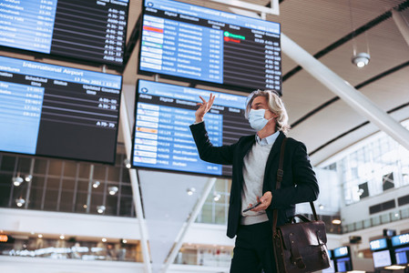 Businessman at airport traveling post pandemic lockdown