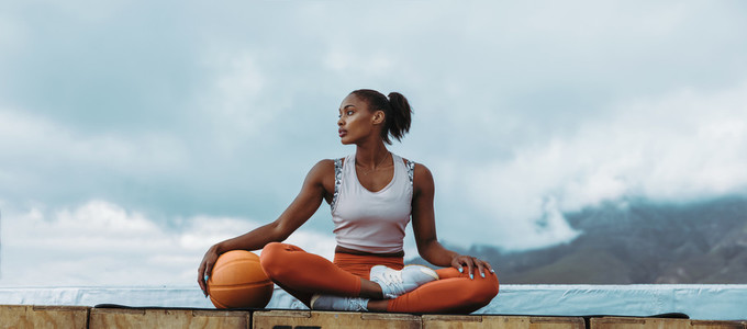 Athlete woman relaxing with basketball outdoors