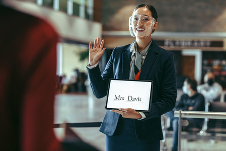 Airport stewardess welcoming Mr Davis