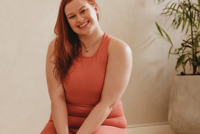 Woman taking a break after yoga workout at home