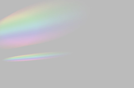 Abstract of blurred rainbow prism light overlay on grey backgrou