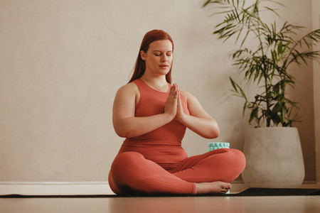 Fitness woman meditating in lotus pose
