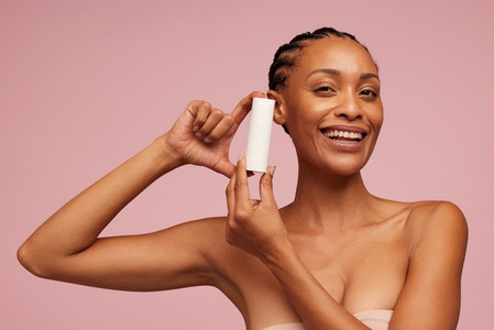 Woman showing skincare product
