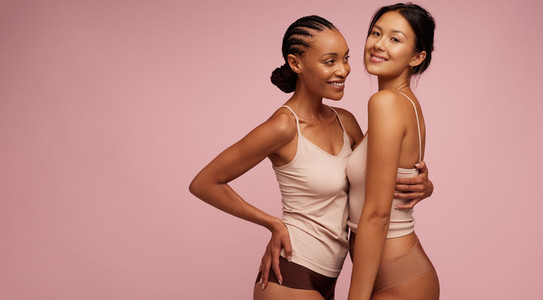 Women in lingerie standing together and smiling