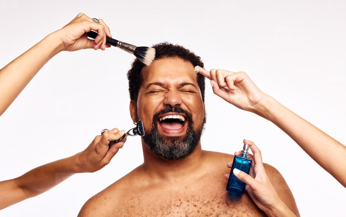 Happy bearded man having facial grooming