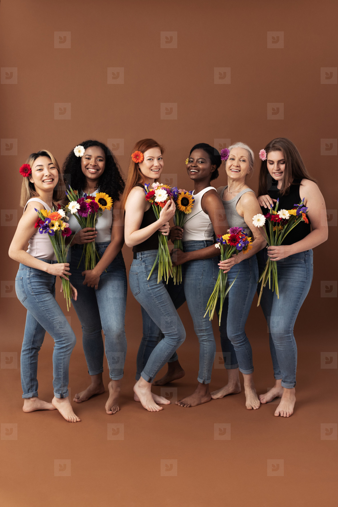 Full body shot of six women of different ages standing together with bouquets of flowers  Smiling women in casuals with flowers in hair