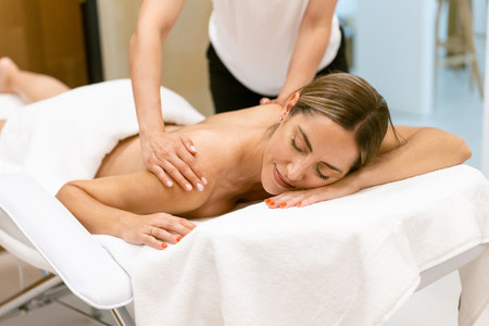 Middle aged woman having a back massage in a beauty salon