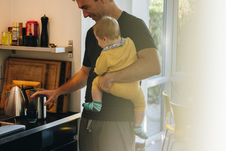 Man making coffee with baby