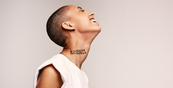 Cheerful woman with express yourself written on neck