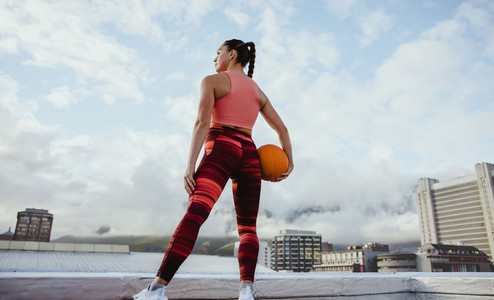 Fitness woman with basketball in hand