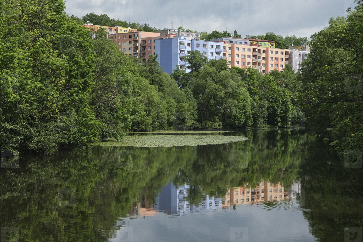 Pastel apartment buildings behind idyllic lake #Czechoslovakia